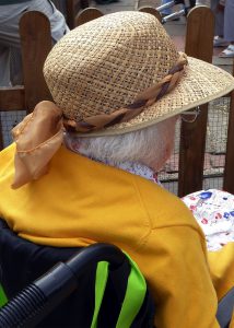 Image of woman with hat in wheelchair